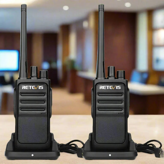 Two black walkie-talkies with charging docks.
