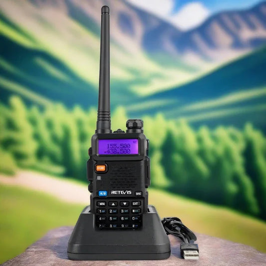 Handheld two-way radio with antenna and digital display, sitting on a charging base.