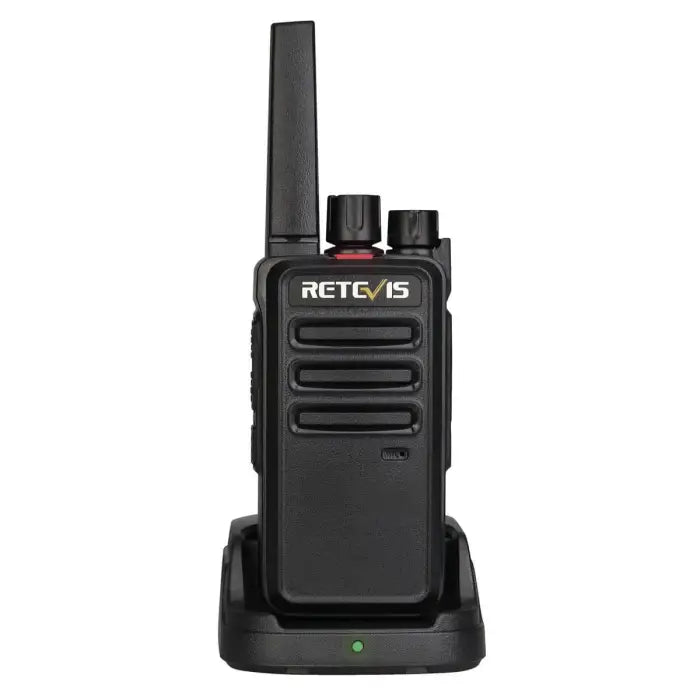Black two-way radio on charging base.