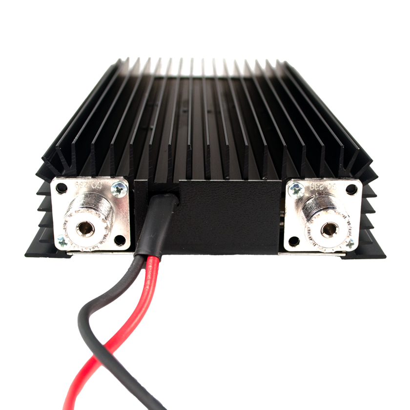 Black heat sink with coaxial connectors and power cables.