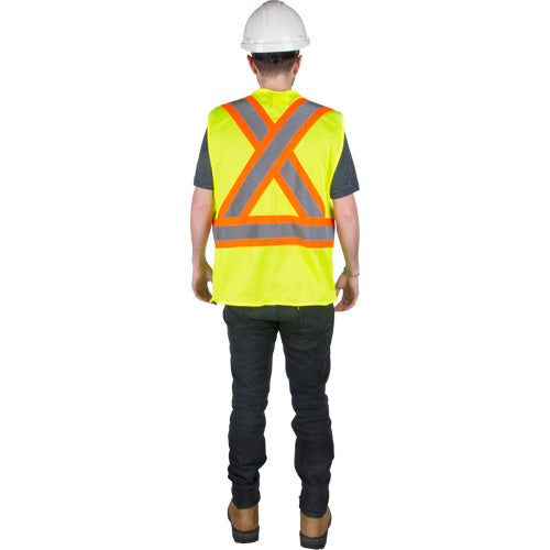 Rear view of a person wearing a high-visibility safety vest with reflective X-pattern and horizontal stripes.
