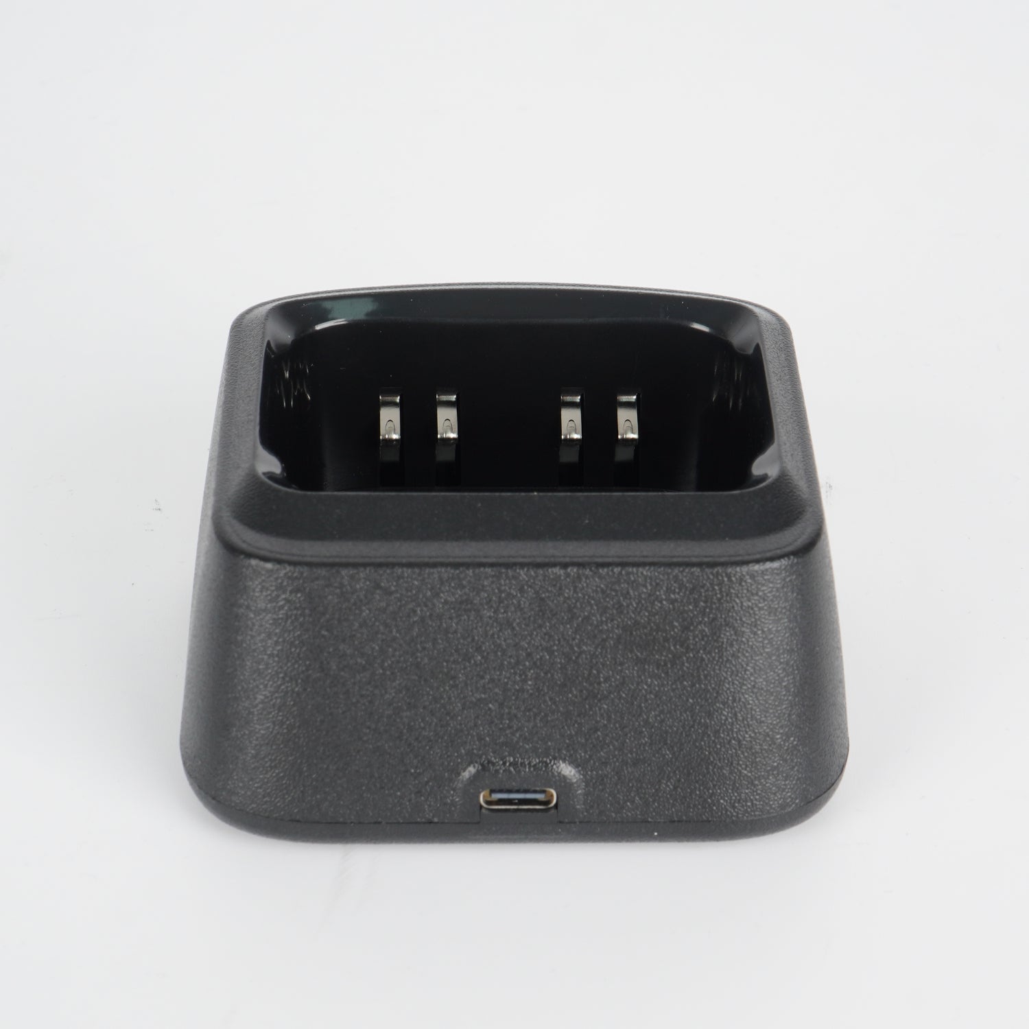 Black charging dock with usb port and three-pronged connector for device charging