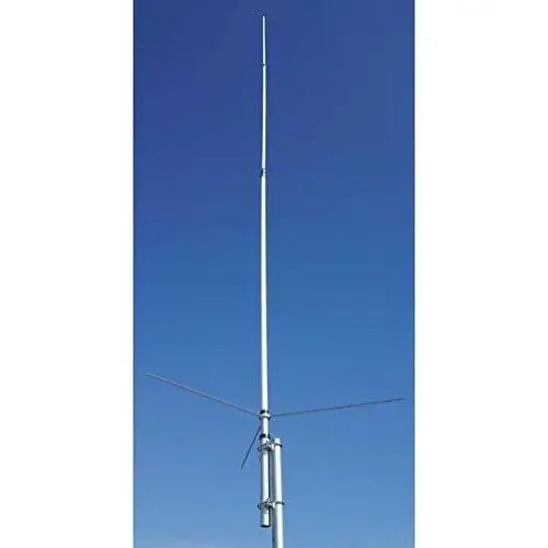Vertical antenna with horizontal elements mounted on a pole against a blue sky.