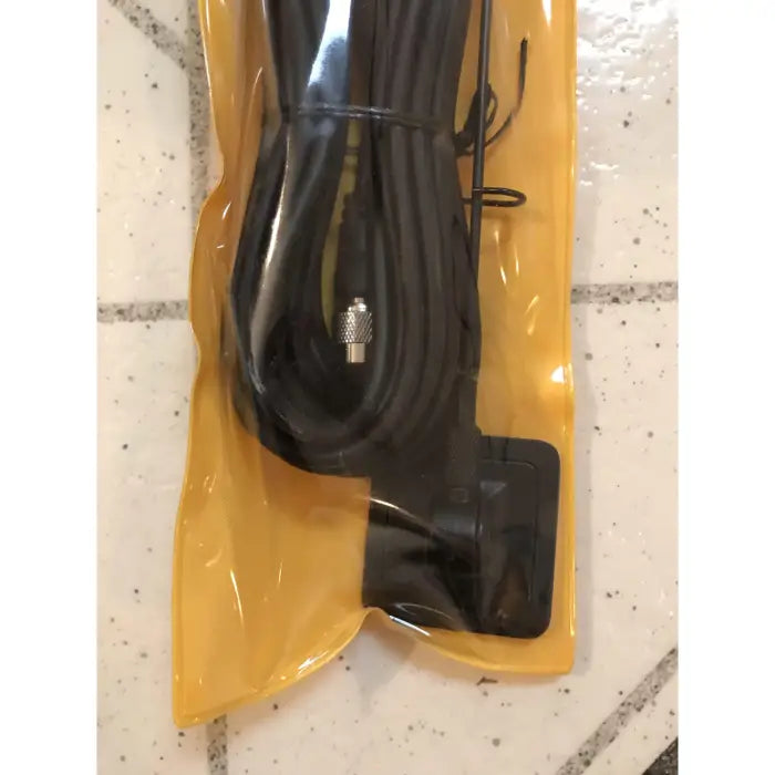 Black antenna with cable in yellow packaging.